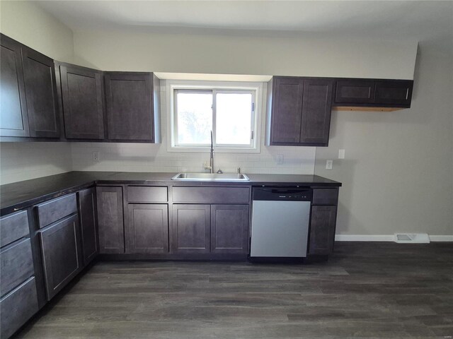 kitchen featuring dishwashing machine, dark brown cabinets, dark hardwood / wood-style floors, and sink