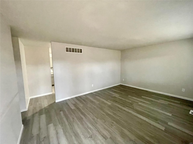 spare room with dark hardwood / wood-style flooring