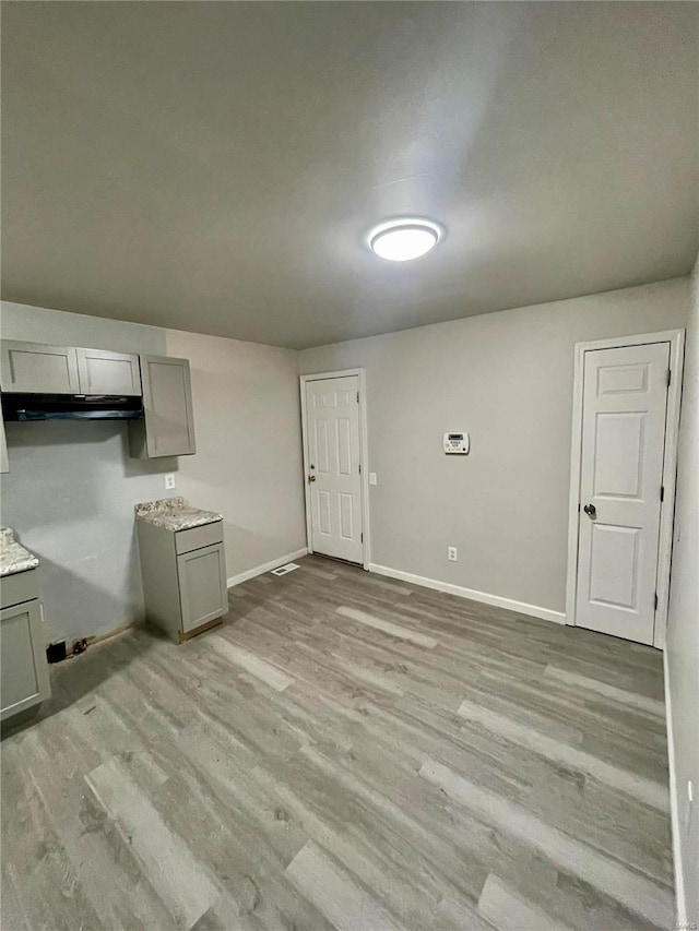 interior space with gray cabinetry and light hardwood / wood-style floors