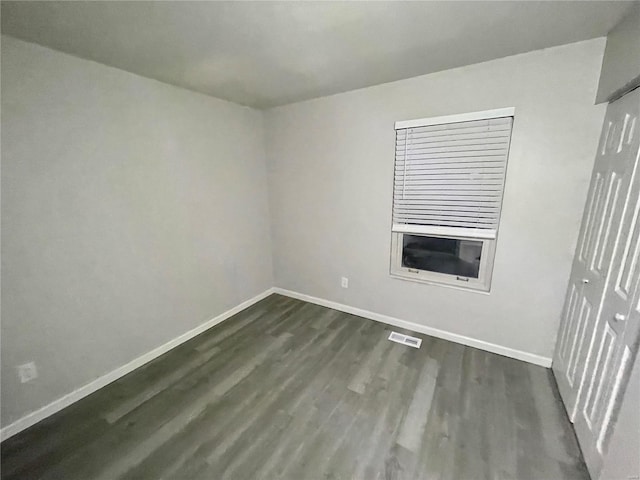 unfurnished room featuring dark hardwood / wood-style floors