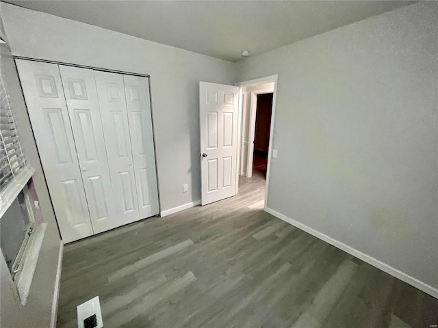 unfurnished bedroom with hardwood / wood-style floors and a closet