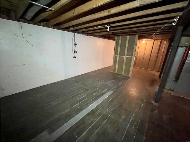 basement featuring dark wood-type flooring