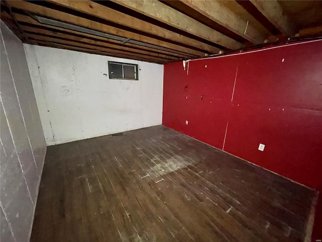 basement with dark hardwood / wood-style flooring