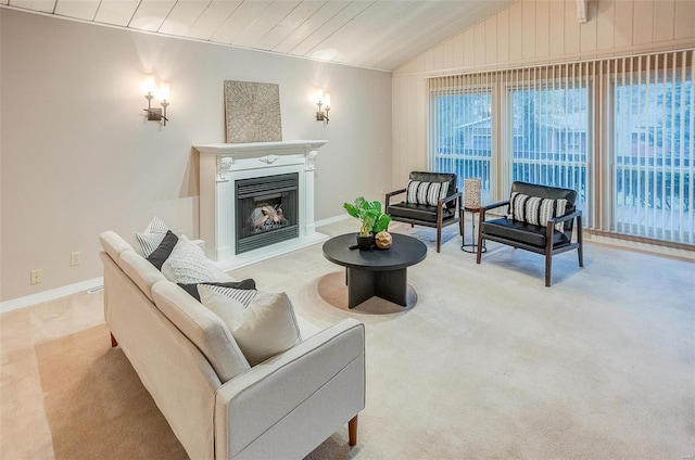 carpeted living room with a healthy amount of sunlight, wooden ceiling, and vaulted ceiling