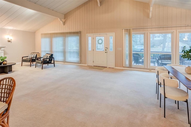 interior space featuring beam ceiling, a wealth of natural light, and high vaulted ceiling