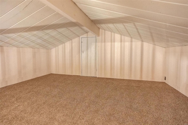 bonus room with carpet flooring and lofted ceiling with beams