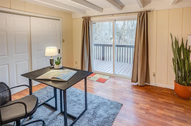 home office with beamed ceiling and light hardwood / wood-style floors