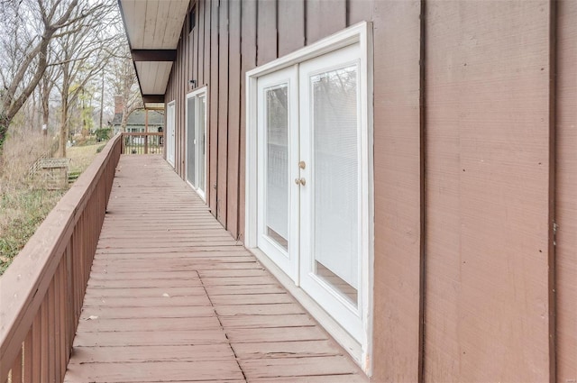 wooden balcony with french doors and a deck