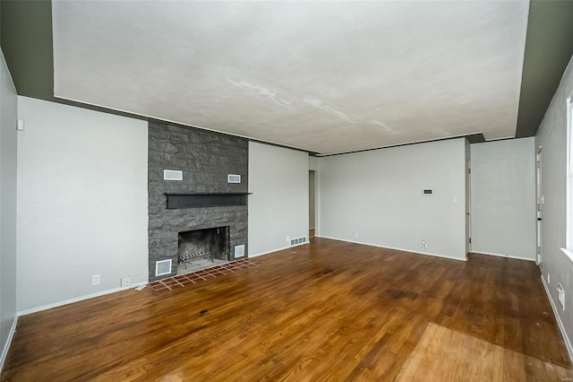 unfurnished living room with a fireplace and hardwood / wood-style flooring