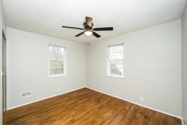 spare room with hardwood / wood-style floors and ceiling fan