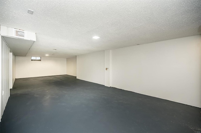 basement featuring a textured ceiling