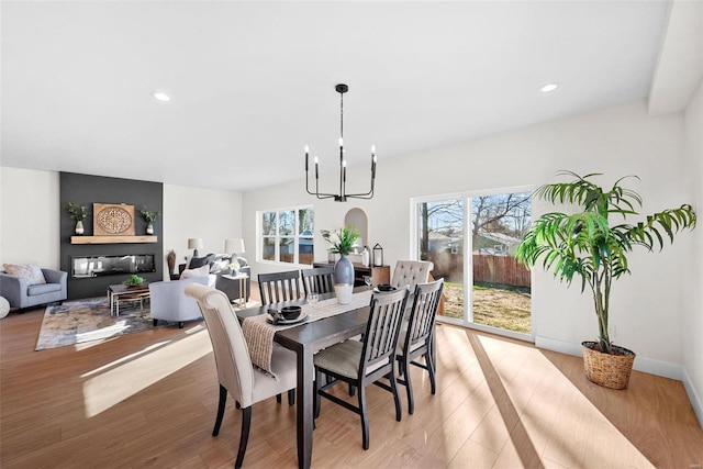 dining room featuring plenty of natural light, a notable chandelier, and light wood-type flooring