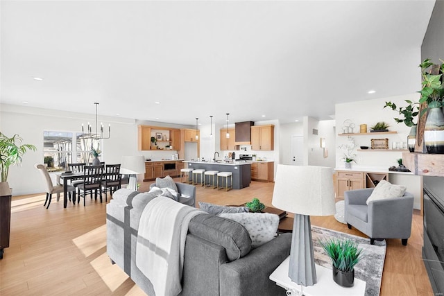 living room featuring light hardwood / wood-style flooring and sink