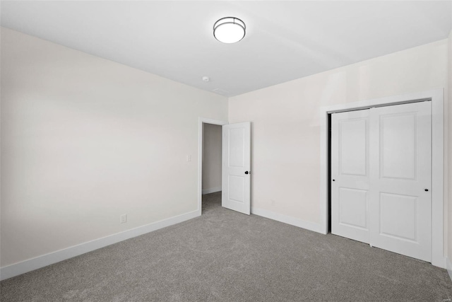 unfurnished bedroom featuring carpet and a closet