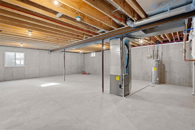 basement featuring heating unit and electric water heater