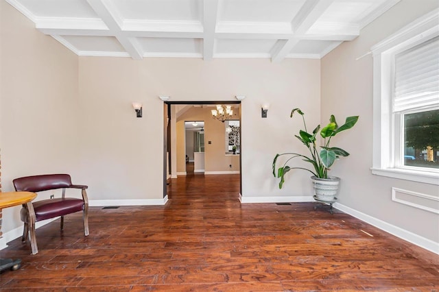 corridor featuring dark wood-type flooring, beam ceiling, coffered ceiling, and a notable chandelier