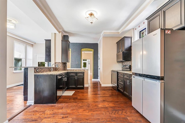 kitchen with tasteful backsplash, dark wood-type flooring, stainless steel appliances, and dark brown cabinets