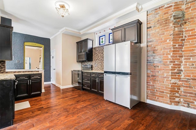 kitchen featuring light stone counters, backsplash, dark hardwood / wood-style flooring, and stainless steel appliances