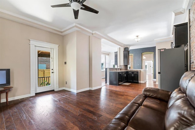 living room with ceiling fan, sink, dark hardwood / wood-style flooring, and ornamental molding