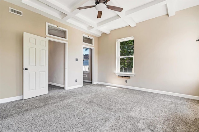 unfurnished bedroom with ceiling fan, carpet flooring, coffered ceiling, and beamed ceiling