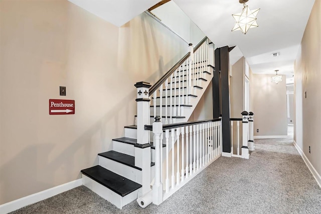 stairs with an inviting chandelier and carpet flooring