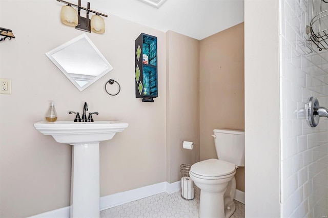 bathroom featuring toilet and walk in shower