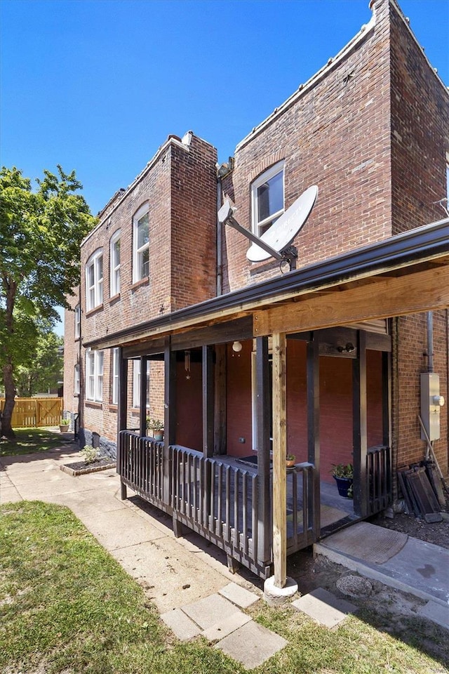 view of side of property featuring covered porch