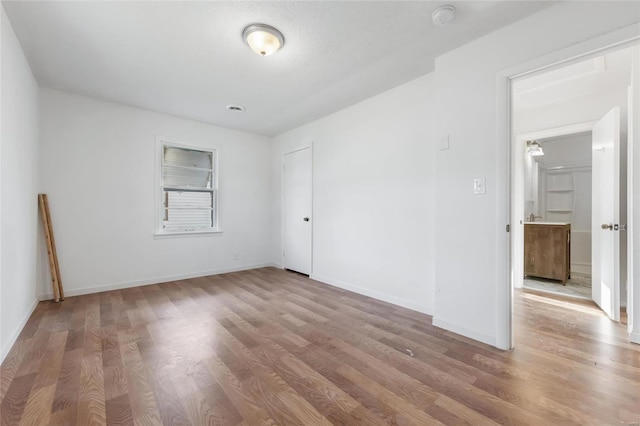 spare room with wood-type flooring and a textured ceiling