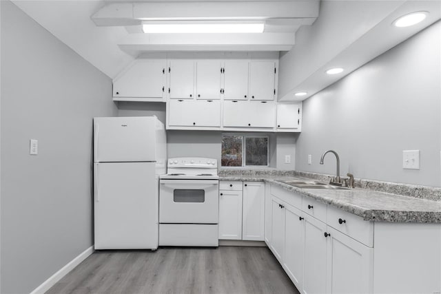 kitchen featuring white appliances, sink, vaulted ceiling with beams, light hardwood / wood-style floors, and white cabinetry