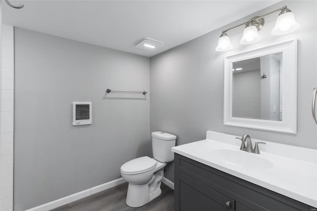 bathroom featuring hardwood / wood-style floors, vanity, and toilet