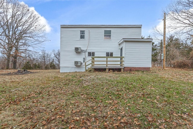 rear view of house with a yard and a wooden deck