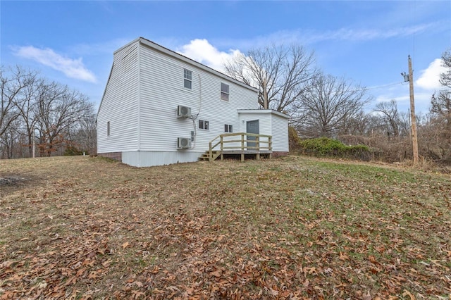 back of house featuring a wall mounted air conditioner and a wooden deck