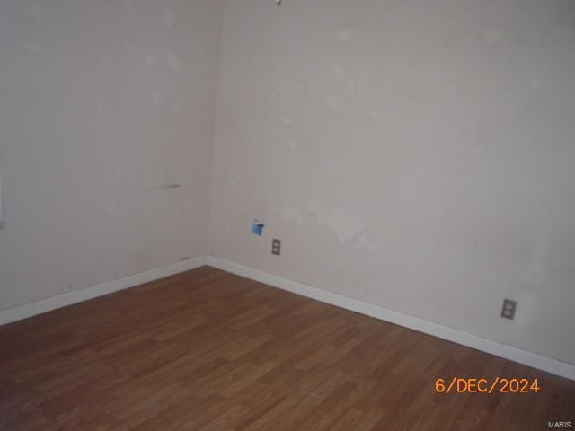 unfurnished room featuring dark hardwood / wood-style flooring