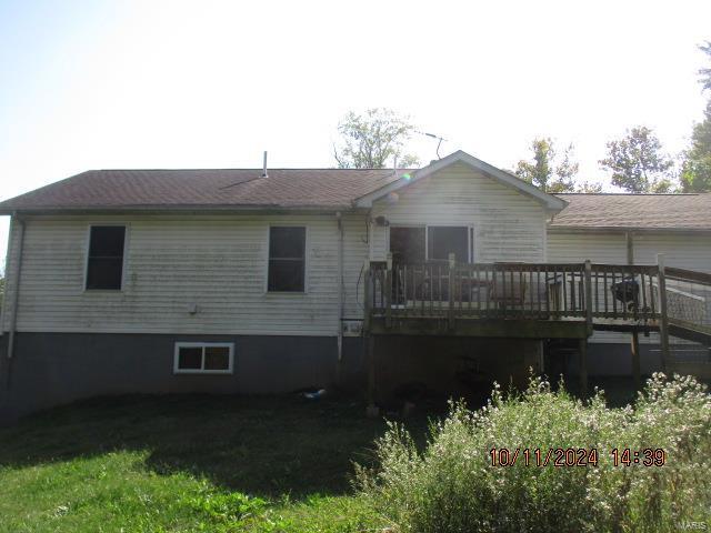 back of property featuring a wooden deck