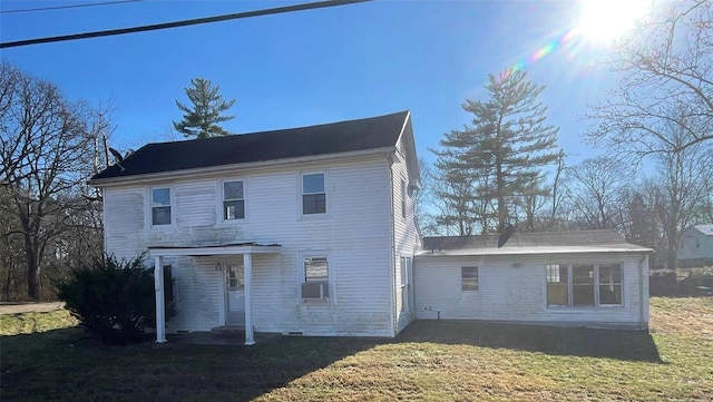 back of house with a yard and cooling unit