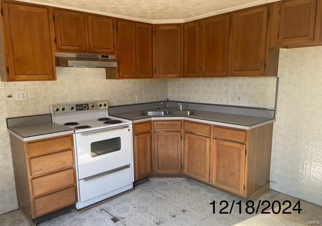 kitchen with white electric range and sink