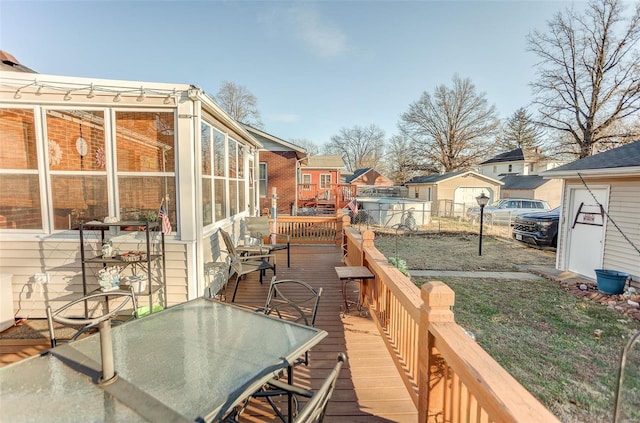 wooden deck with a sunroom