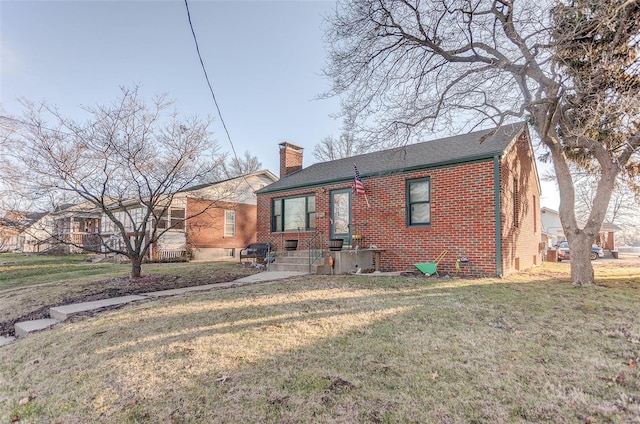 rear view of house featuring a lawn