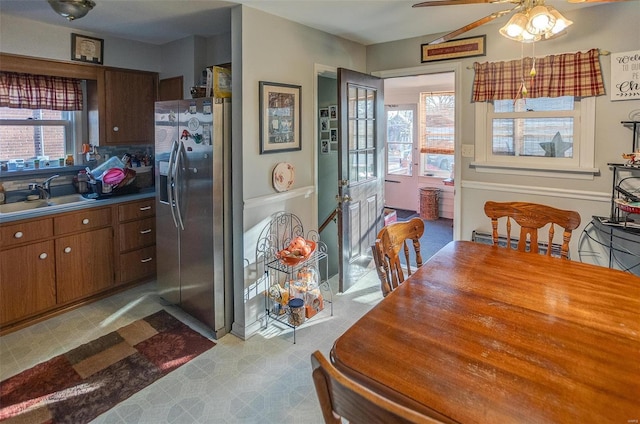 dining space featuring ceiling fan and sink