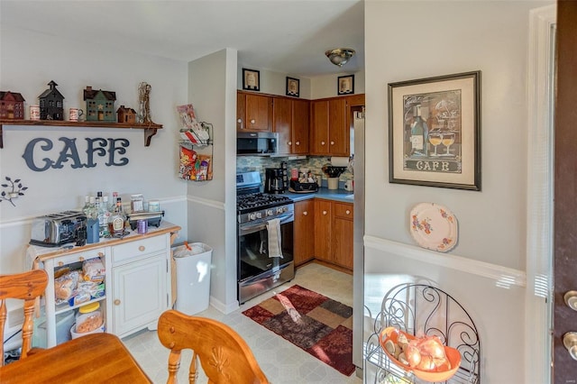 kitchen featuring decorative backsplash and stainless steel gas range