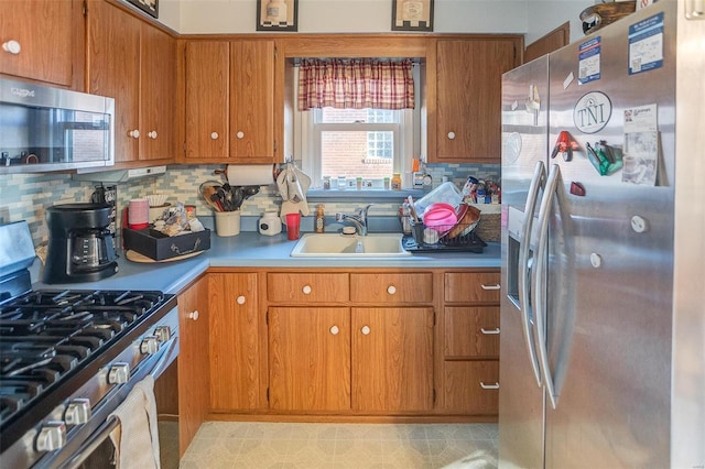 kitchen with stainless steel appliances, tasteful backsplash, and sink