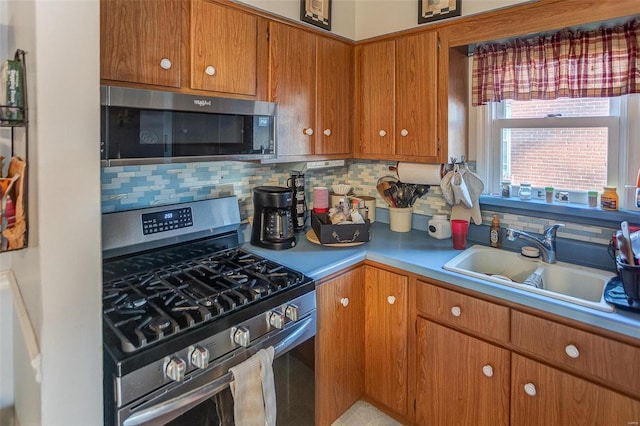 kitchen featuring appliances with stainless steel finishes, tasteful backsplash, and sink