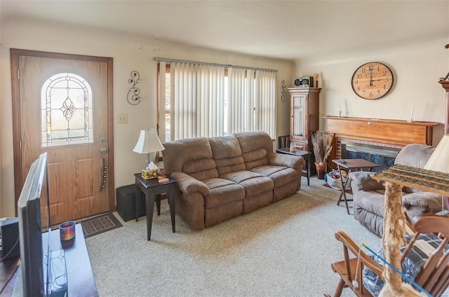 living room featuring carpet and a brick fireplace