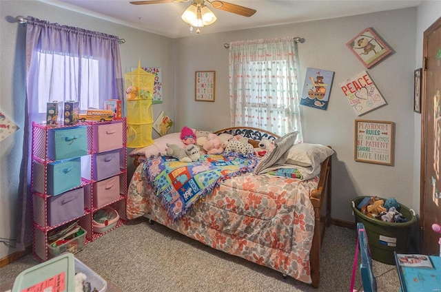 carpeted bedroom with multiple windows and ceiling fan