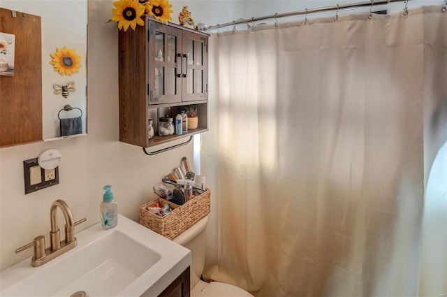 bathroom featuring vanity and toilet