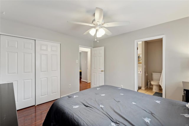 bedroom featuring hardwood / wood-style floors, a closet, ceiling fan, and ensuite bathroom