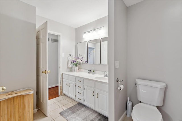 bathroom featuring tile patterned flooring, vanity, and toilet