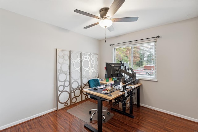 home office with dark hardwood / wood-style flooring and ceiling fan