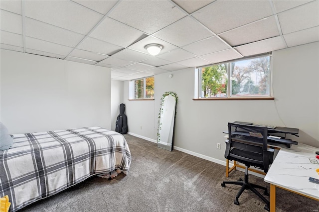 carpeted bedroom with a paneled ceiling