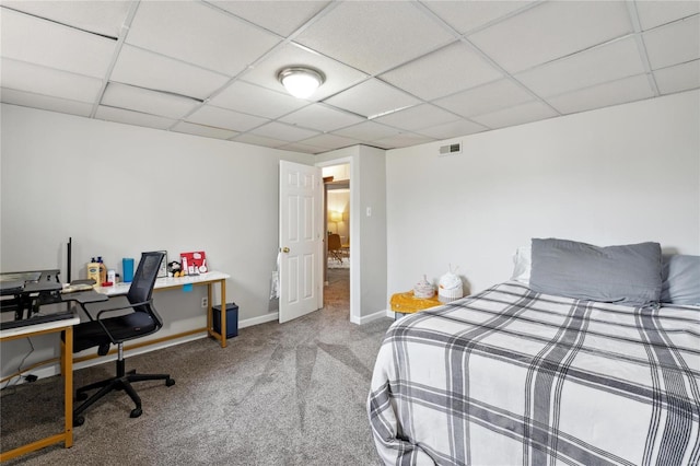 bedroom featuring a paneled ceiling and carpet